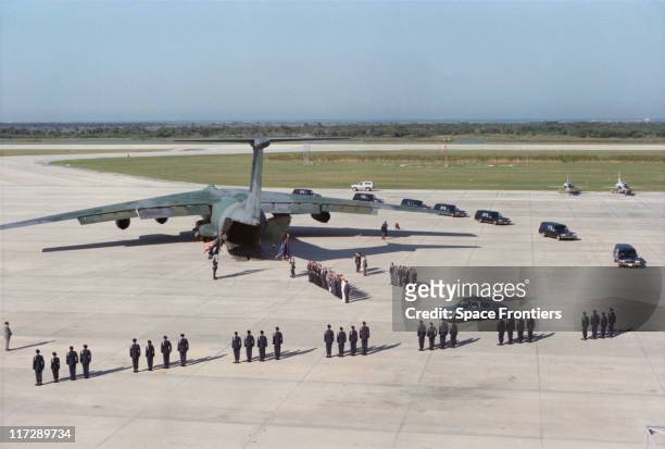 The remains of the crew of the space shuttle 'Challenger' are moved from the Shuttle Landing Facility at the Kennedy Space Center on Merritt Island,...