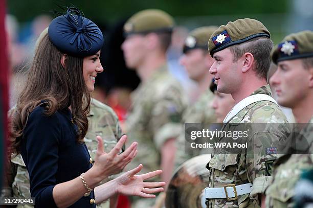 Catherine, Duchess of Cambridge speaks with soldiers in Victoria Barracks during a medal parade for the 1st Battalion Irish Guards Regiment on June...