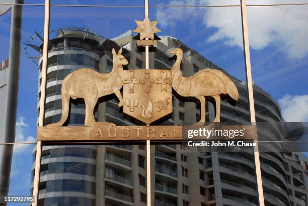 the australian coat of arms as seen on building exterior - parliament house canberra stock pictures, royalty-free photos & images