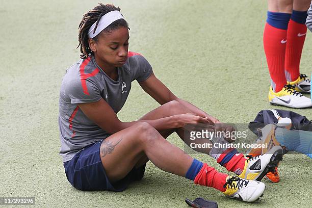 Elodie Thomis puts on her shoes during the France Women national team training session at Rhein-Neckar Arena on June 25, 2011 in Sinsheim, Germany.