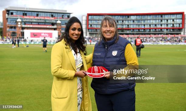 Jane Powell is presented with a cap from her services to coaching by Isa Guha during day four of the 4th Specsavers Ashes Test match between England...