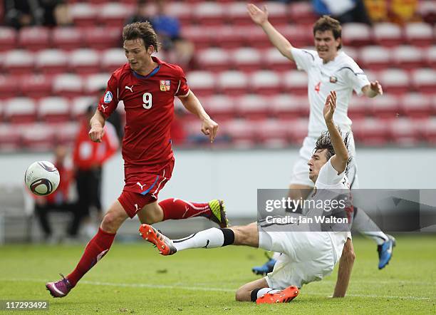 Yegor Filipenko of Belarus attempts a tackle on Libor Kozak of Czech Republic during the UEFA European U21 Championship third place playoff match...