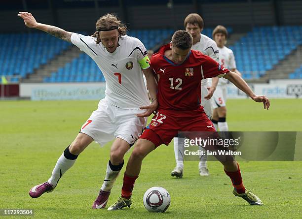 Mikhail Sivakov of Belarus tackles Jan Kovarik of Czech Republic during the UEFA European U21 Championship third place playoff match between Czech...