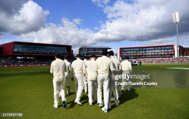 England fielders walk out for the 3rd innings during day four of the 4th Specsavers Ashes Test match between England and Australia at Old Trafford on...