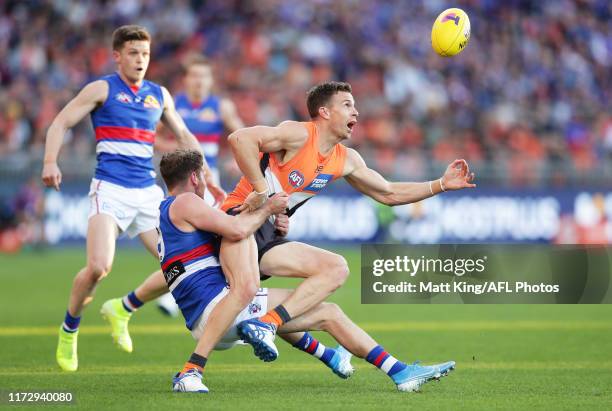 Brett Deledio of the Giants is challenged by Hayden Crozier of the Bulldogs during the AFL 2nd Elimination Final match between the Greater Western...