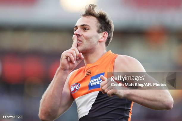 Jeremy Finlayson of the Giants gestures to Bulldogs fans as he celebrates kicking goal during the AFL 2nd Elimination Final match between the Greater...