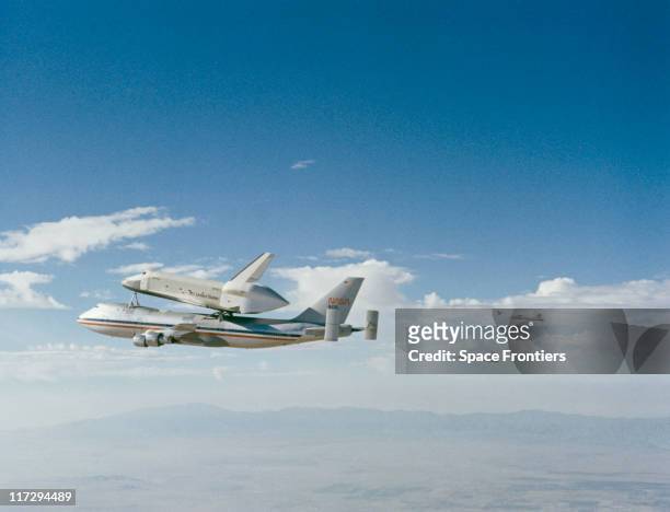 The prototype Space Shuttle Enterprise riding 'piggy-back' on the Boeing 747 Shuttle Carrier Aircraft before the first free flight of the Shuttle...