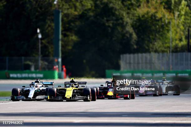 Lewis Hamilton of Great Britain driving the Mercedes AMG Petronas F1 Team Mercedes W10 and Nico Hulkenberg of Germany driving the Renault Sport...