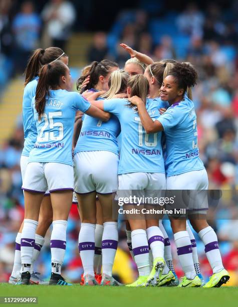 Caroline Weir of Manchester City celebrates after scoring her team's first goal with Demi Stokes and team mates during the Barclays FA Women's Super...