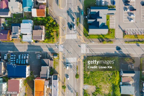 aerial view of road intersection - zona urbana fotografías e imágenes de stock