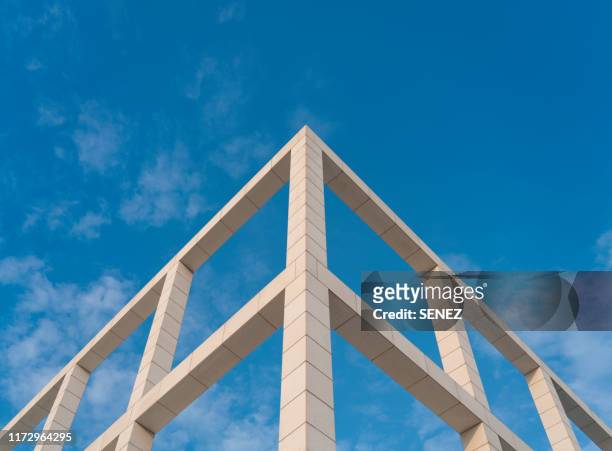 low angle view of building against blue sky - building low angle stockfoto's en -beelden