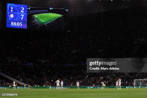 Dejected Tottenham Hotspur players look on as the giant screen reflects the 2-7 defeat late in the game during the UEFA Champions League group B...