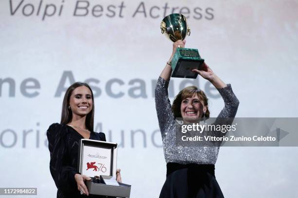 Ariane Ascaride receives the Coppa Volpi for Best Actress Award for "Gloria Mundi" and a Jaeger-LeCoultre Unique engraved Reverso watch during the...