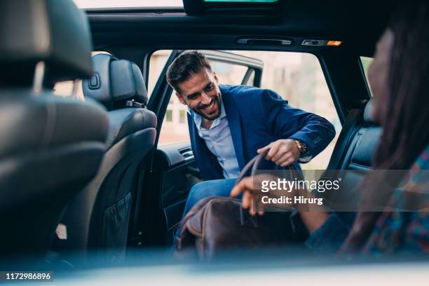 man entering a car - entering stock pictures, royalty-free photos & images