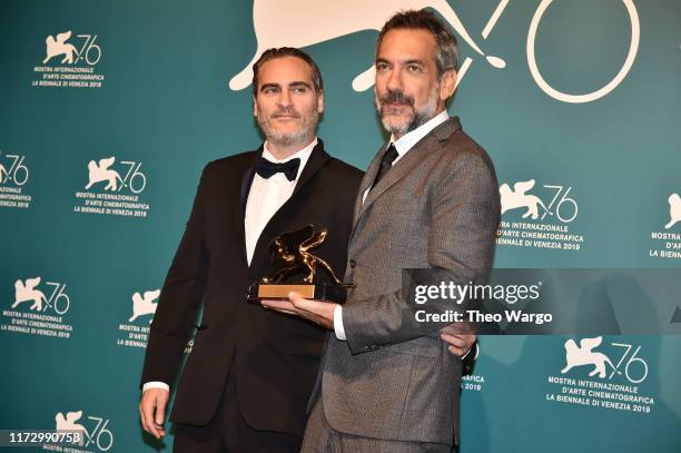 Joaquin Phoenix and Todd Phillips pose with the Golden Lion for Best Film Award for ‘Joker’ at the Winners Photocall during the 76th Venice Film...