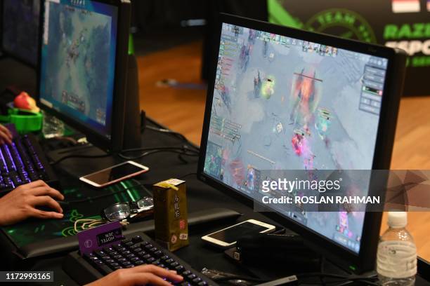 This photograph taken on September 2, 2019 shows participants attending an Esports bootcamp training session in Singapore. - Teenage gamers worldwide...