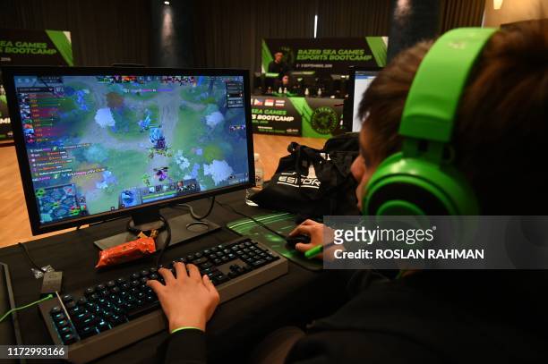 This photograph taken on September 2, 2019 shows a participant attending an Esports bootcamp training session in Singapore. - Teenage gamers...