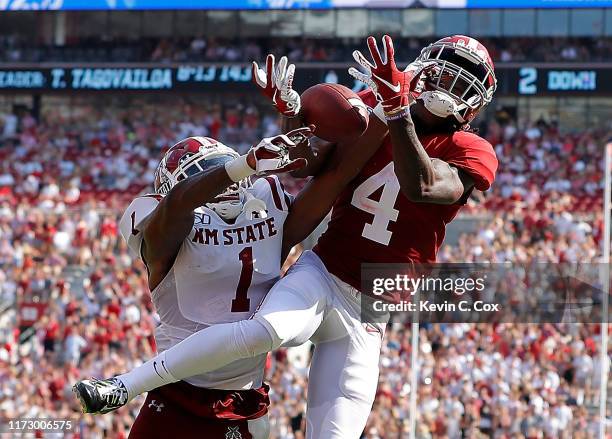 Jerry Jeudy of the Alabama Crimson Tide fails to pull in this reception as he is defended by Ray Buford Jr. #1 of the New Mexico State Aggies at...