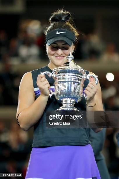 Bianca Andreescu of Canada celebrates with the championship trophy during the trophy presentation ceremony after winning the Women's Singles final...