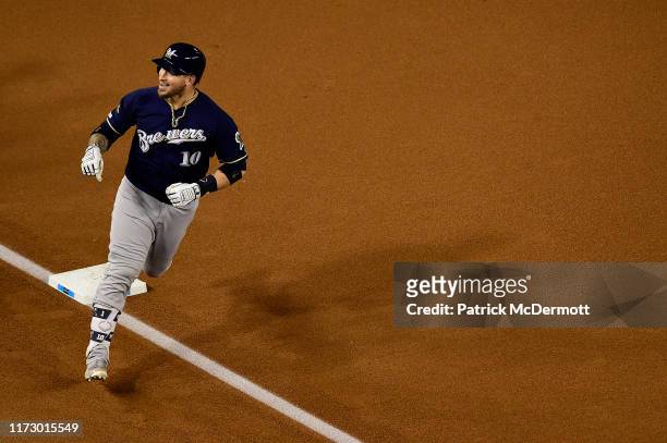 Yasmani Grandal of the Milwaukee Brewers celebrates after hitting a two run home run to score Trent Grisham against Max Scherzer of the Washington...