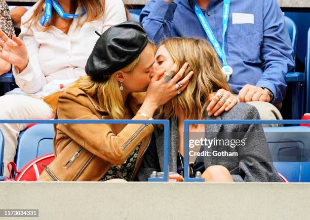 Cara Delevingne and Ashley Benson share a kiss during the 2019 US Open Women's final on September 07, 2019 in New York City.