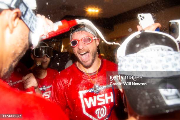 Max Scherzer of the Washington Nationals celebrates with teammates after the Washington Nationals defeated the Milwaukee Brewers for the National...