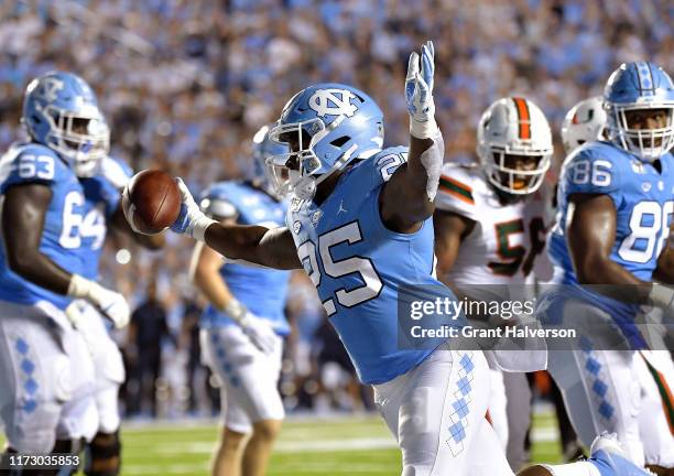 Javonte Williams of the North Carolina Tar Heels reacts after scoring a touchdown against the Miami Hurricanes during the first quarter of their game...