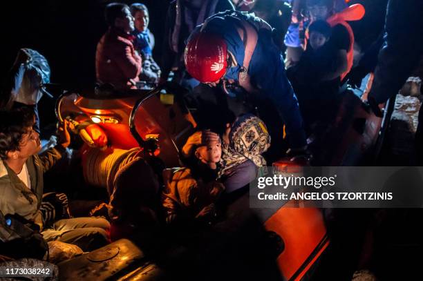 Migrants are seen on board a ''Refugee Rescue NGO'' rescue boat, following a rescue operation by a Frontex patrol vessel, at the port of Skala...