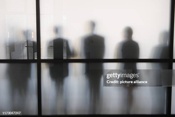 October 2019, Saxony, Dresden: During a break in the session, CDU members of parliament stand behind a glass pane in a conference room and stand out...