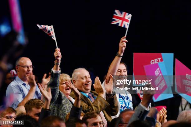 Delegates applaud and wave Union flags as Prime Minister Boris Johnson delivers his keynote speech on day four of the 2019 Conservative Party...