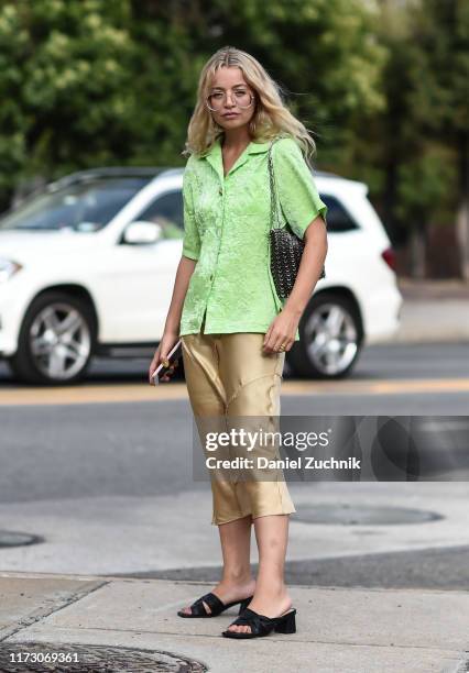 Stephanie Broek is seen wearing a green top, gold skirt and black shoes outside the Area show during New York Fashion Week S/S20 on September 07,...