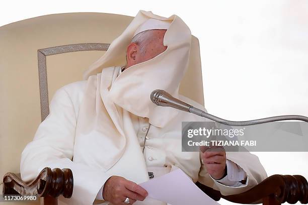 Gust of wind lifts the cassock of Pope Francis during the weekly general audience on October 2, 2019 at St.Peter's square in the Vatican.