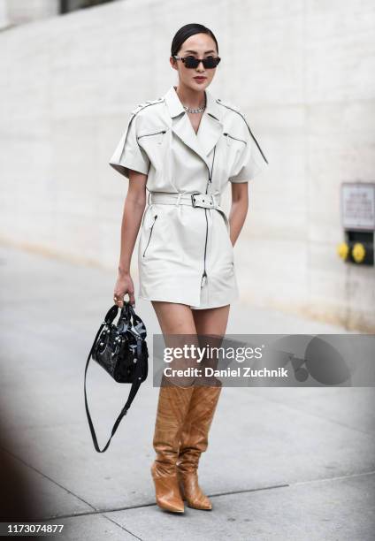 Chriselle Lim is seen wearing a Longchamp outfit and brown cowboy boots outside the Longchamp show during New York Fashion Week S/S20 on September...