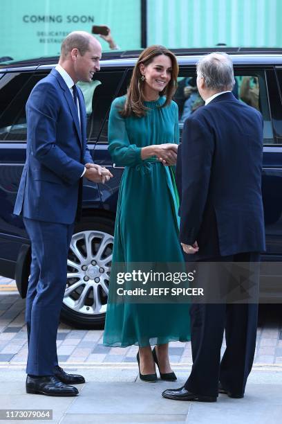 Britain's Prince William, Duke of Cambridge and Britain's Catherine, Duchess of Cambridge are greeted by Prince Shah Karim Al Hussaini, Aga Khan IV...