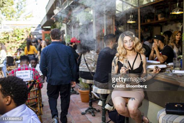 Customer smokes marijuana at the Lowell Cafe, a new cannabis lounge in West Hollywood, California, U.S., on Tuesday, Oct. 1, 2019. America's first...