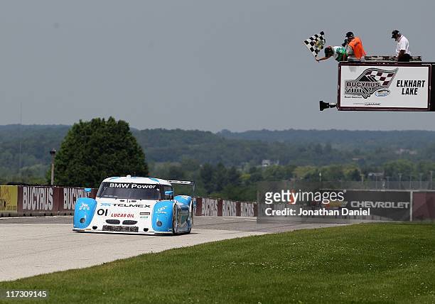 Scott Pruett, driver of the 01 Chip Ganassi Racing with Felix Sabates BMW Riley, crosses the finish line to win the Grand-Am Rolex Series at Road...
