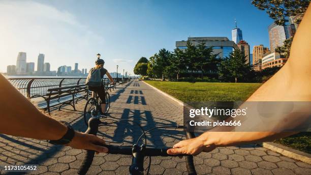 pov bicycle riding: man with road racing bike in new york - battery park stock pictures, royalty-free photos & images