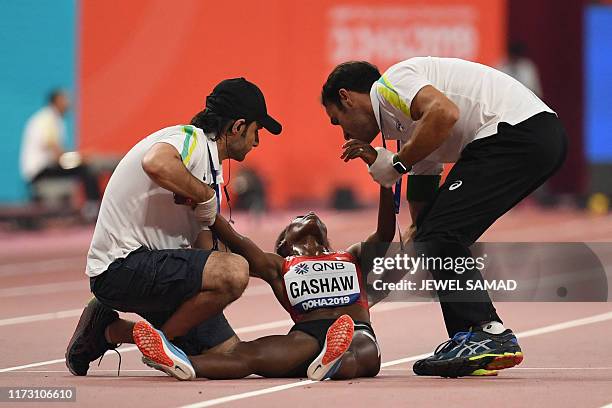 Bahrain's Tigist Gashaw receives medical attention in the Women's 5000m heats at the 2019 IAAF Athletics World Championships at the Khalifa...
