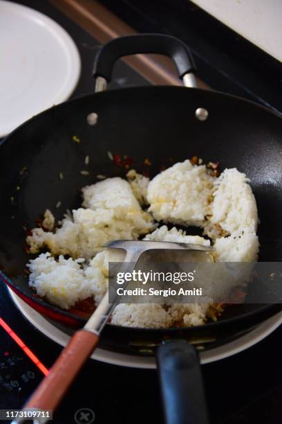 preparing chinese fried rice in a wok - チャーハン ストックフォトと画像