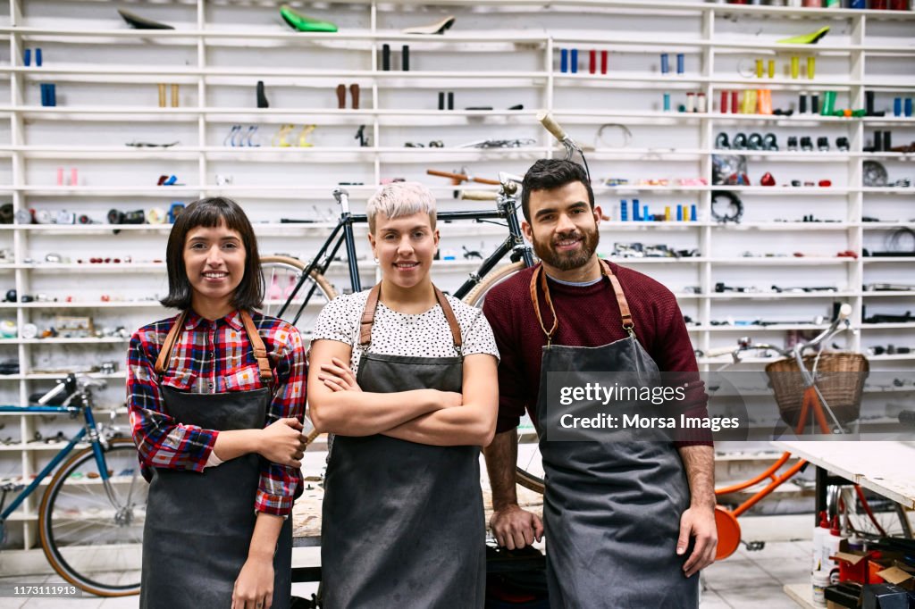Portrait of smiling young coworkers at workshop