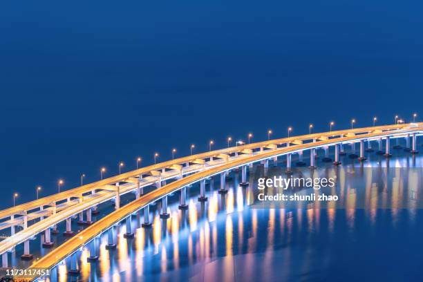 close-up of sea-crossing bridge - illuminated bridge stock pictures, royalty-free photos & images