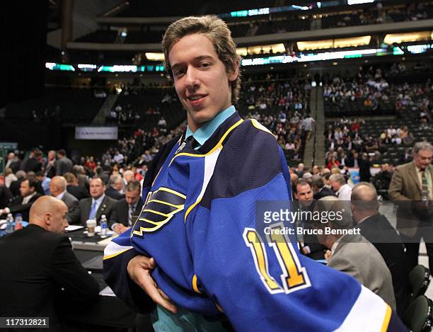 88th overall pick Jordan Binnington by the St. Louis Blues puts on the St. Louis Blues jersey during day two of the 2011 NHL Entry Draft at Xcel...