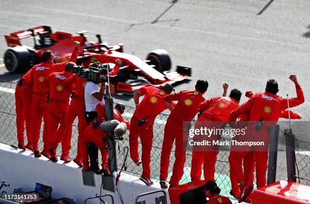 Race winner Charles Leclerc of Monaco driving the Scuderia Ferrari SF90 passes his team celebrating on the pitwall during the F1 Grand Prix of Italy...