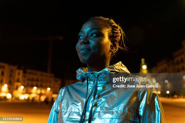 young woman wearing a silver colored jacket - adult imagination stock pictures, royalty-free photos & images