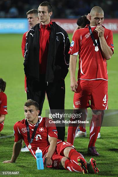 Xherdan Shaqiri and Pajtim Kasami are dejected after their 0-2 defeat during the UEFA European Under-21 Championship Final match between Spain and...