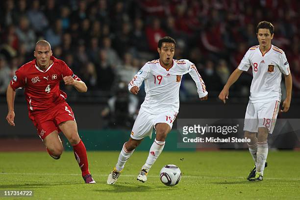 Thiago Alcantara of Spain chased by Pajtim Kasami of Switzerland during the UEFA European Under-21 Championship Final match between Spain and...