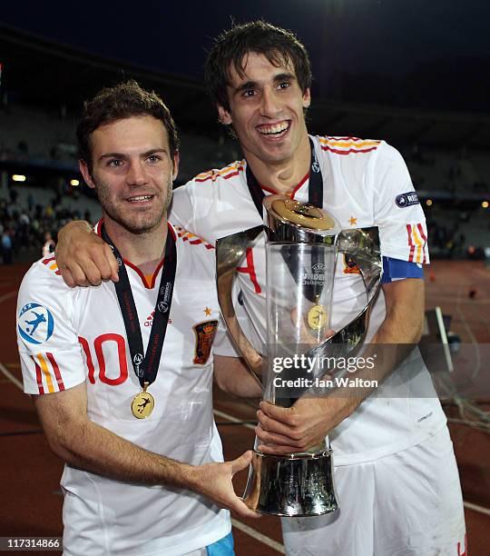 Juan Mata and Javi Martinez the captain of Spain lifts the winners trophy after his sides 2-0 victory after their UEFA European U21 Championship...