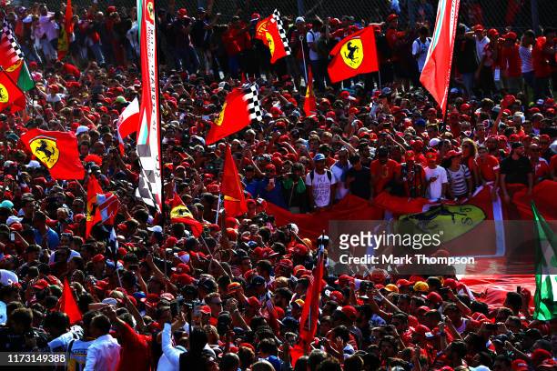 Ferrari fans enjoy the atmosphere at the podium during the F1 Grand Prix of Italy at Autodromo di Monza on September 08, 2019 in Monza, Italy.