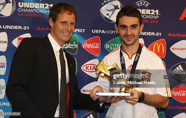 Adrian Lopez of Spain receives the golden boot from Flemming Polvsen after the UEFA European Under-21 Championship Final match between Spain and...