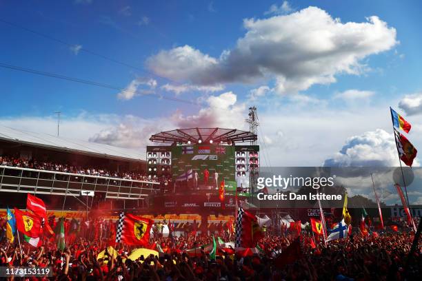 General view as race winner Charles Leclerc of Monaco and Ferrari celebrates on the podium with second placed Valtteri Bottas of Finland and Mercedes...